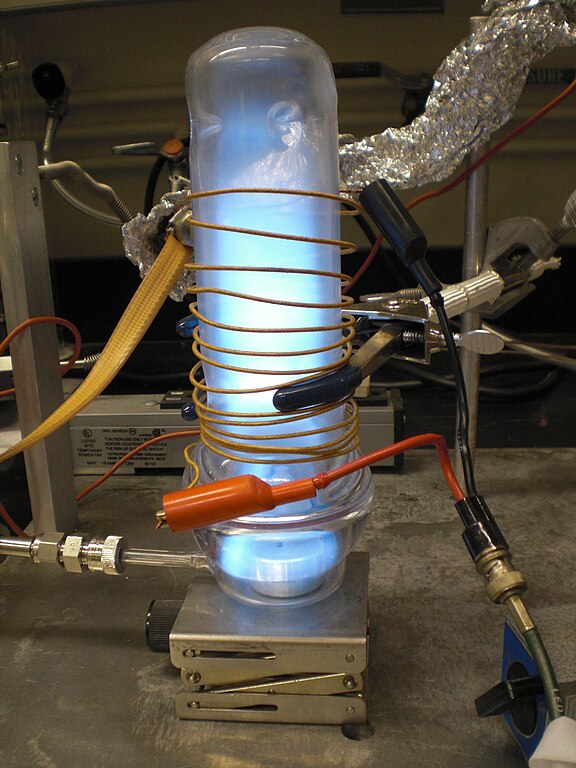Oxygen plasma cleaning in action — the characteristic blue-violet glow of an oxygen plasma inside a reactor chamber